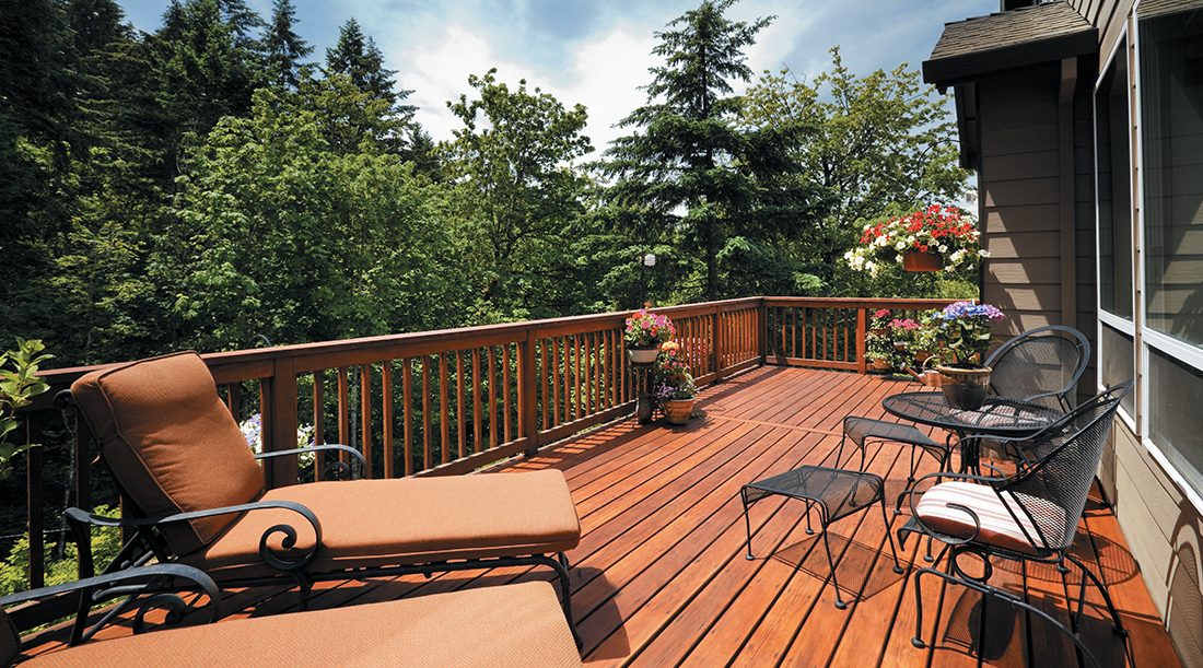 Crew removing old deck boards and installing new composite decking on a Kirkland, WA home