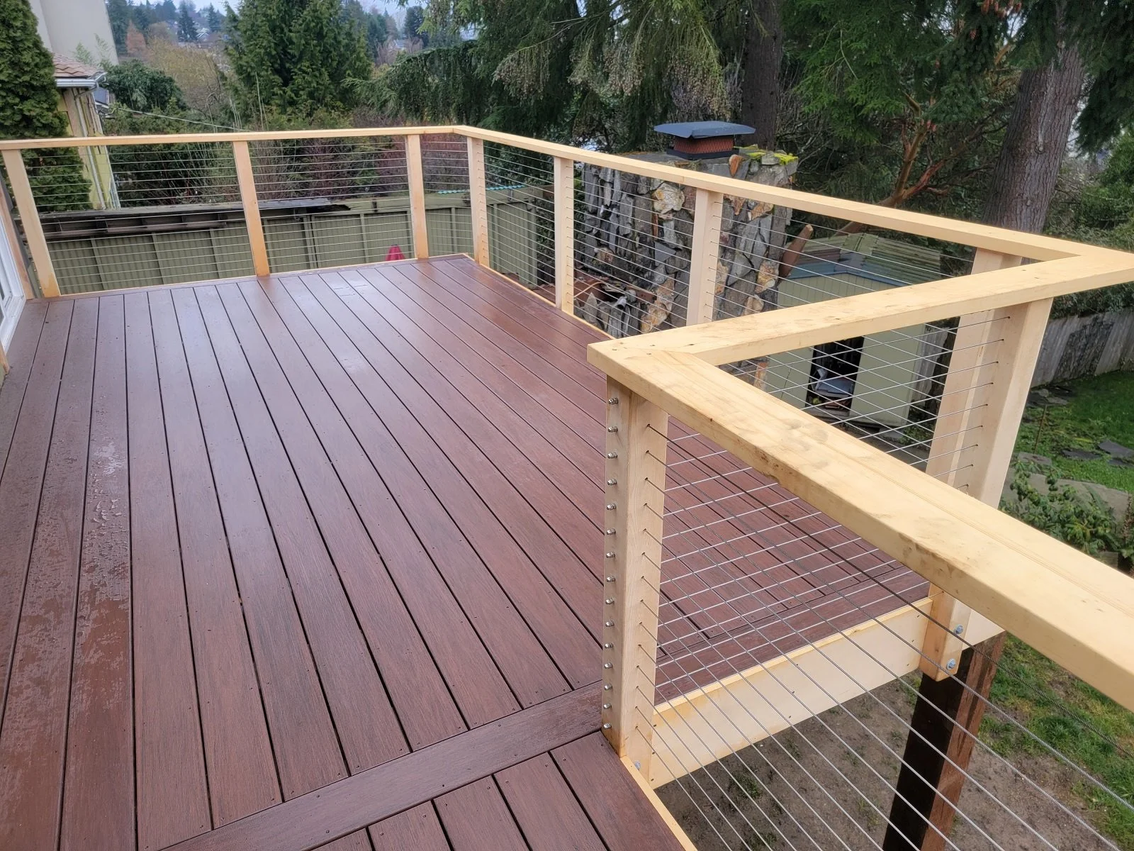 Expert wood deck builder at Seattle Deck Builder LLC discussing material options with Bellevue homeowner