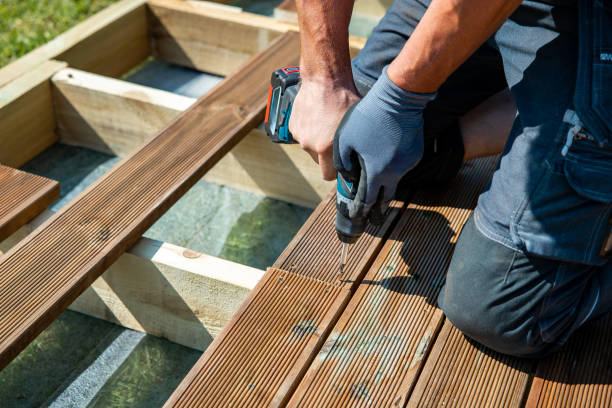 Wood Deck Builder fastening railing components on a raised deck in Sammamish, WA