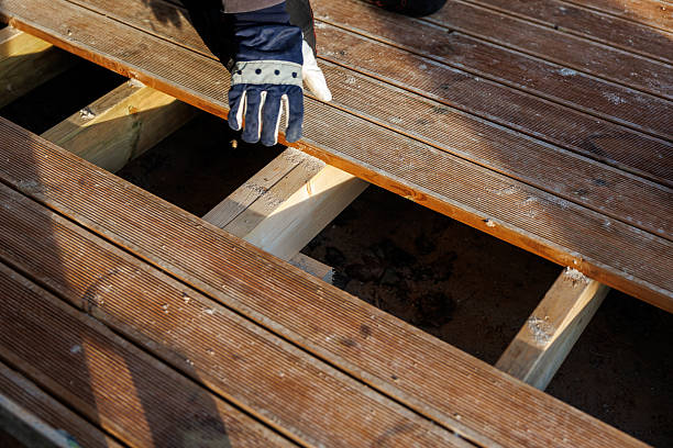 Wood Deck Builder checking railing spacing on a raised backyard deck in Kirkland, WA